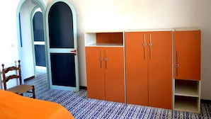 A room with a wardrobe, a chair, and a patterned floor. - Nami Holiday Home for six Guests With Outdoor Space (Melendugno)