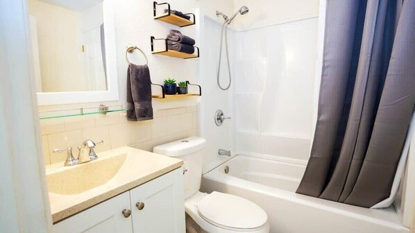 Shower, hair dryer, towels, shampoo
