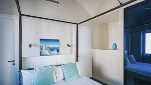 A bedroom with a bed, a painting, a shelf with a bottle, and a window. - Villa Matilde by Elite Villas (Capri)
