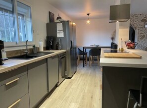 Enjoy cooking in this well-equipped kitchen with a central island, oven, and stovetop.