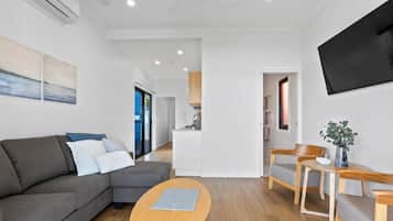 Apartment, 1 King Bed, Beach View | Living area | 50-inch Smart TV with digital channels, Netflix, streaming services