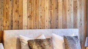 Un lit avec une tête de lit en bois et deux oreillers.