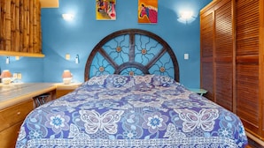 A room with a bed, a wooden headboard, a blue wall, and a wooden wardrobe. - Golden Zone 5 Blocks to Beach - Groundfloor w Pool (Bucerías)