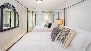 A hotel room with a four-poster bed, a large mirror, and a bedside lamp. - Family-Friendly Home Near Downtown & University (Appleton)
