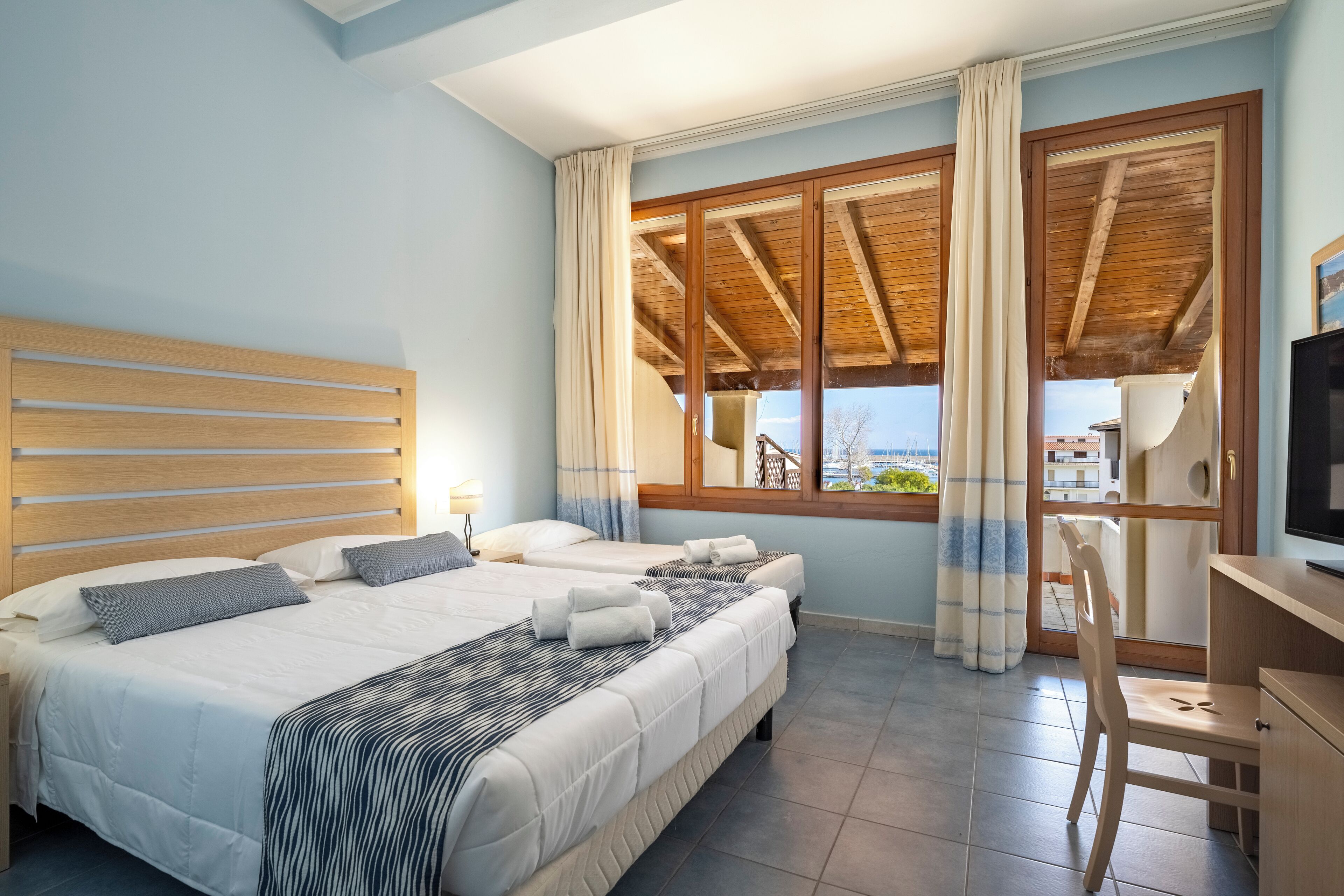 Una camera da letto con un letto grande, una scrivania e vista all'esterno.