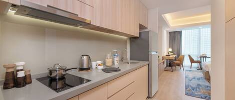 A modern kitchen with a built-in stove, sink, and refrigerator.