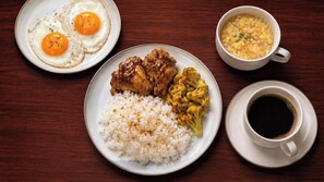 A plate of food with rice, chicken, and vegetables, a cup of coffee, and a bowl of soup. - Somerset Valero Makati (Makati)