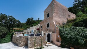 A stone-walled building with a small porch and a pool area. - Butterfly, a historical, fairytale-style, villa with pool & hot tub! (Armeni)