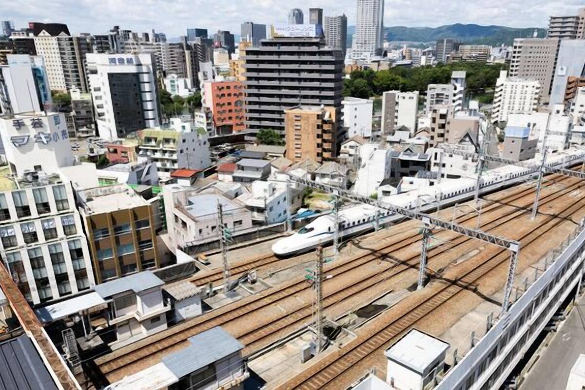 A cityscape with a train track and buildings.