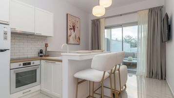 Luxury Suite, Pool View | Private kitchen | Full-size fridge, oven, stovetop, espresso maker