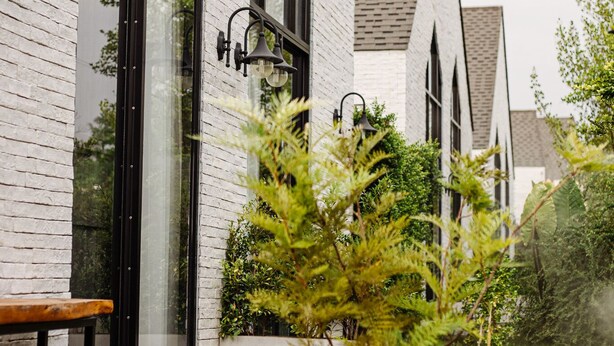 A building with large windows and a bench outside. - Phuping Valley Resort  (Tak)