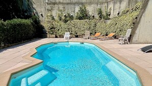 A rectangular swimming pool with a tiled edge, surrounded by a paved deck. - Lovely apartment with AC and a large terrace - pool in the residence. (Nice)