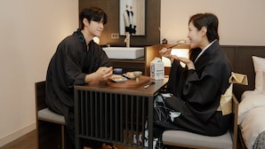A hotel room with a dining table, a bed, and a bedside table with a lamp. - Anook Ryokan Hotel Paju (Paju)