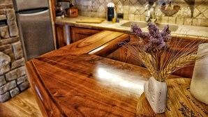 A kitchen with a wooden countertop, a stone wall, and a built-in oven. - Residenza del Colle (Montelanico (Rome))