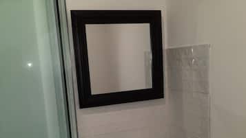 Een douche, handdoeken, zeep, shampoo