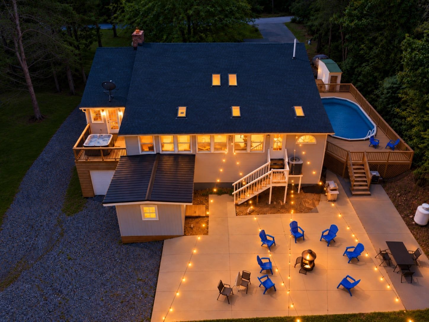 A house with a swimming pool, outdoor seating, and a covered patio area.