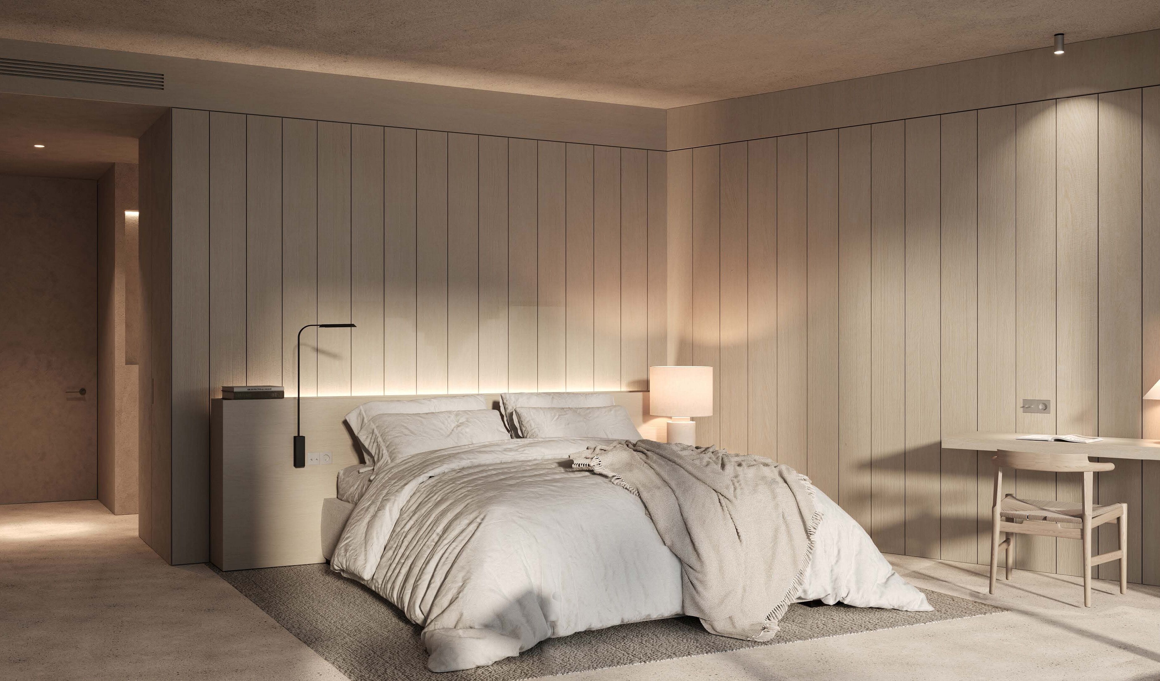 A modern bedroom with a bed, bedside table, and a desk with a chair.