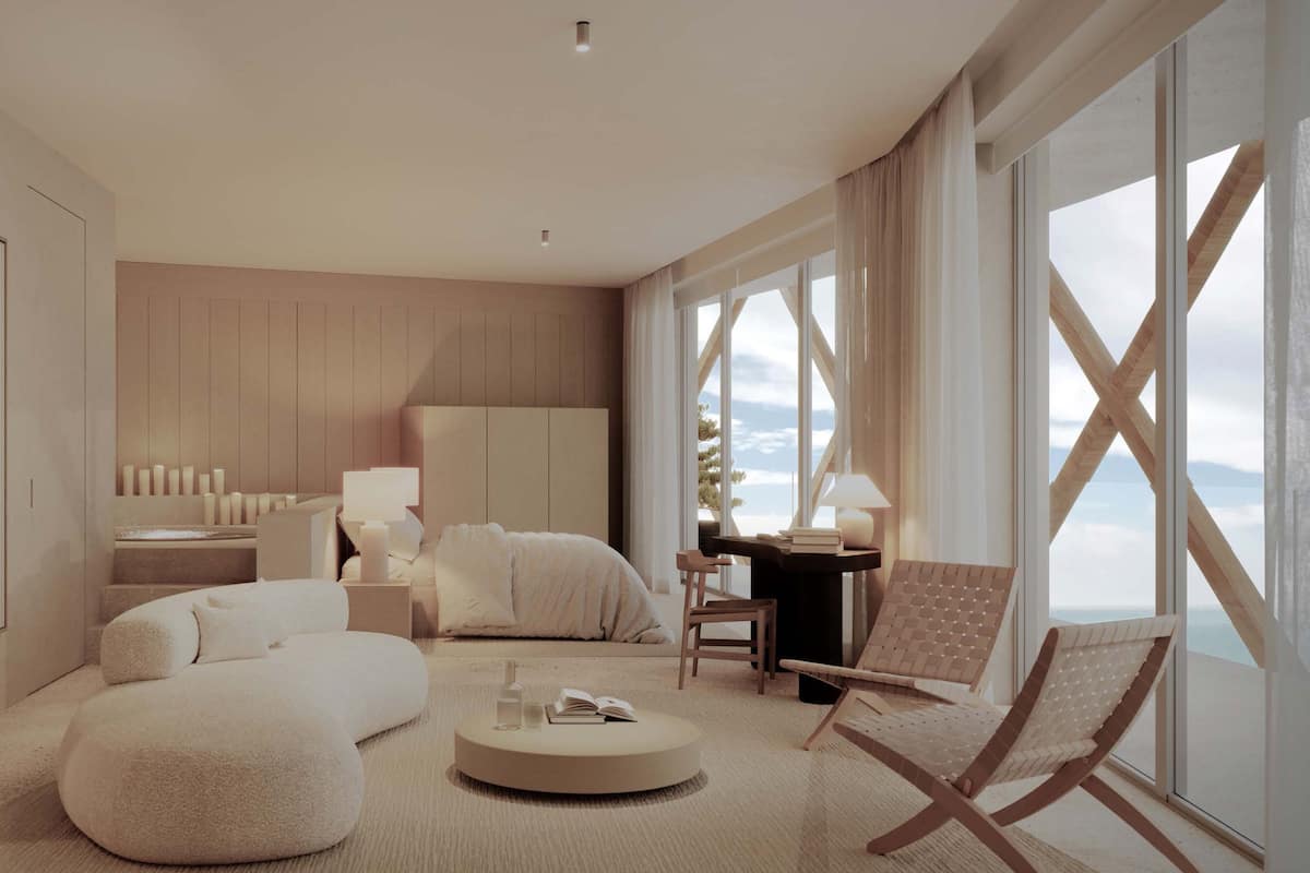 Ein modernes Schlafzimmer mit einem großen Bett, einer Sitzecke mit einem runden Couchtisch und Meerblick durch große Fenster.