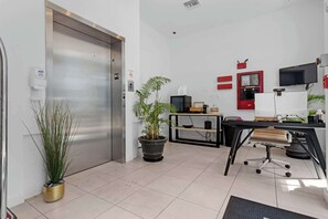 Work in comfort with a desk, computer, and TV in this functional office space.