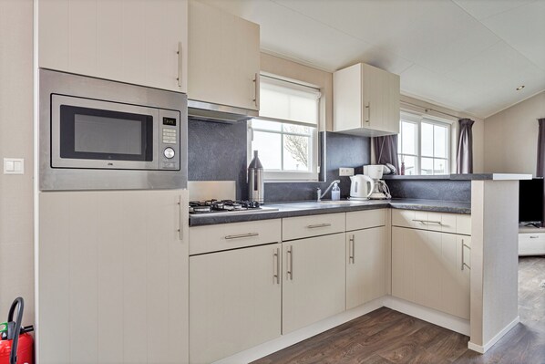 Fridge, microwave, stovetop, coffee/tea maker