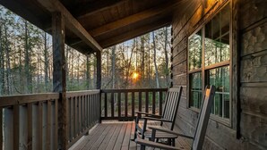 A wooden cabin with a porch, two rocking chairs, and a view of a forest. - 🏡 Luxury Smoky Mountain Retreat | Mega Spa, Game Room & Stunning Views (Cosby)