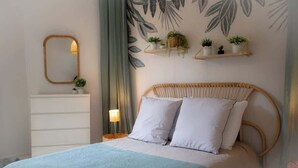A bedroom with a bed, a dresser, a mirror, and wall-mounted shelves with plants. - Sublime 2, Bollaert, 4 pers, centre ville (Lens)
