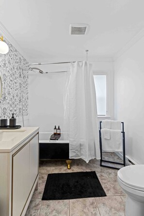 Un baño con ducha, inodoro y lavabo.