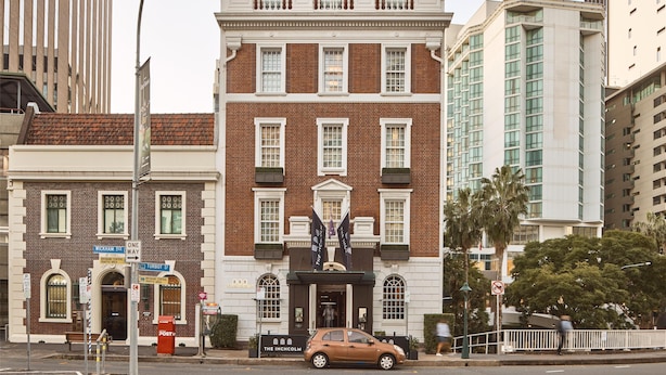 A historic building with a central entrance, a flag, and a sign indicating 'The Inchmole'. - The Inchcolm by Ode Hotels (Spring Hill)