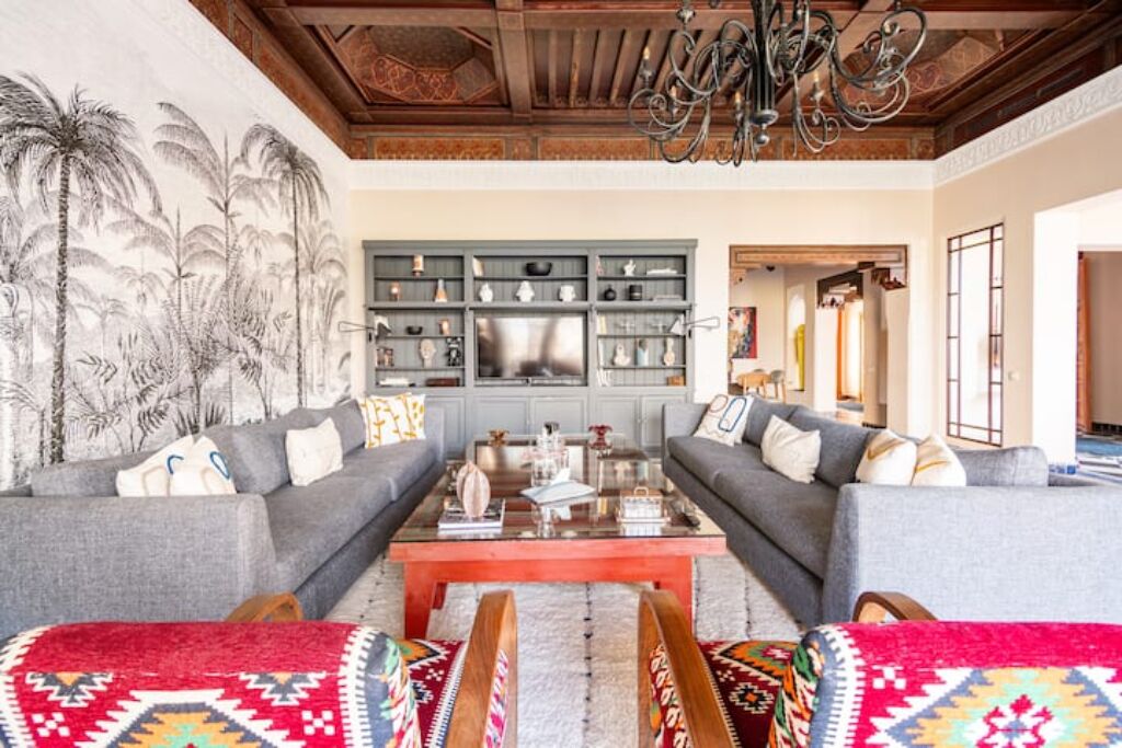 A living room with two grey sofas, a coffee table, and a bookshelf.