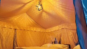 A tent-style room with two beds, a hanging light fixture, and a window. - Riverstone Camps and Resorts (Yamkeshwar)