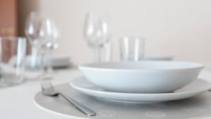 A dining table set with a white bowl, plate, fork, and knife. - Italianway - Campania 26 A (Milan)