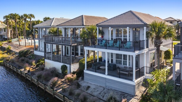 A waterfront house with a balcony, a pool, and a view of the water. - Waterfront Villa*Steps to Beach*Pool*King Beds (Destin)