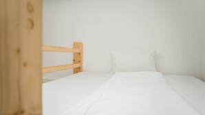 A simple, unadorned room with a wooden bunk bed and white bedding. - Cosy Box @ Boxhagener Platz (Berlin)