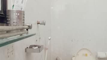 A bathroom with a toilet, sink, and a hand dryer.