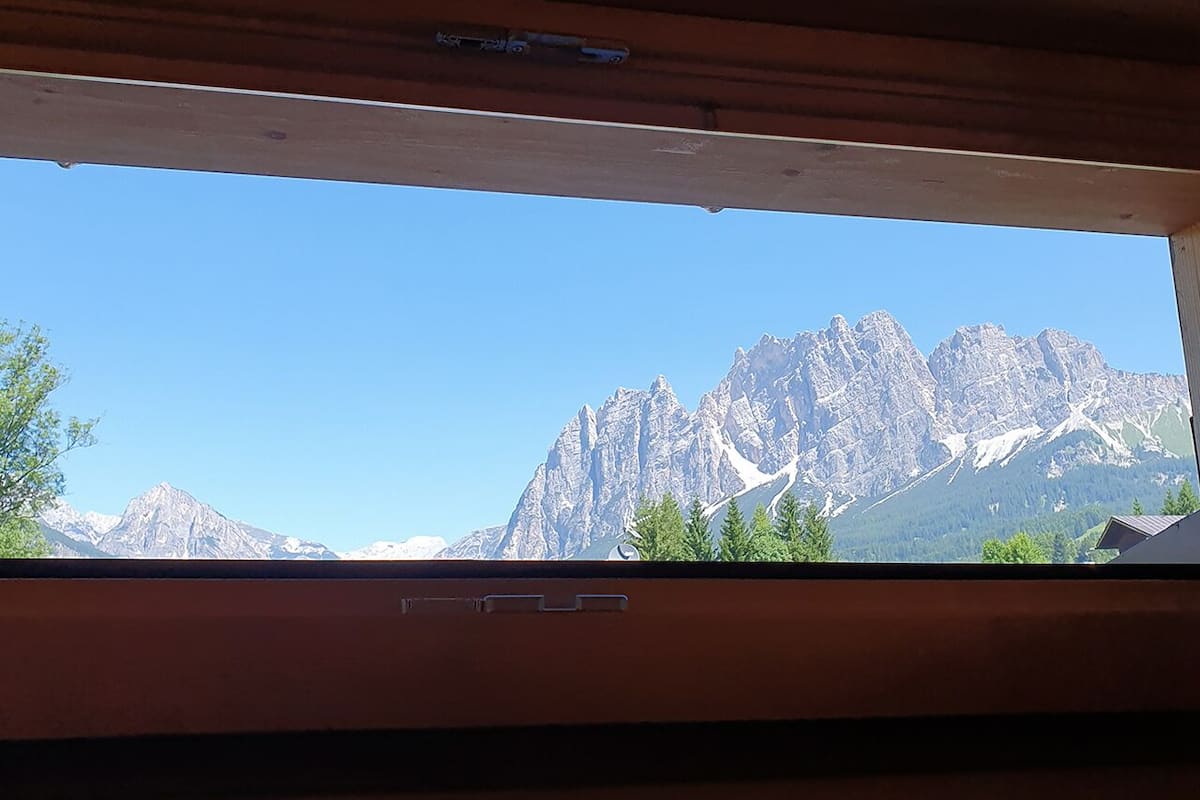 A window with a view of a mountain range.