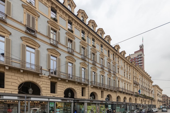 A multi-story building with classical architecture, featuring arched windows and balconies.