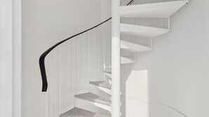 A spiral staircase with white walls and a black handrail. - ID 412 - Beaugrenelle / rue Gaston de Caillavet (studio) (Paris)