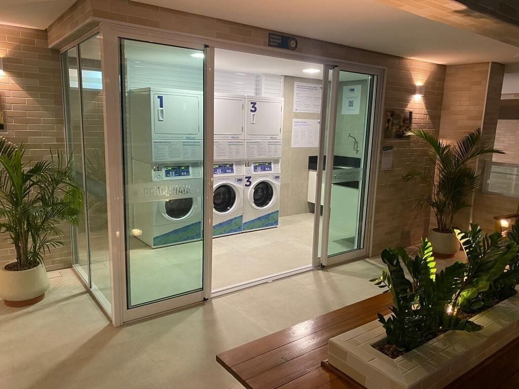 A hotel entrance with a glass door leading to a laundry area.