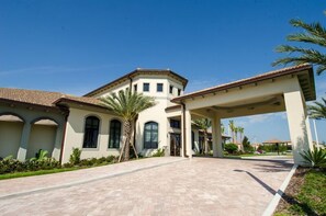 A large building with a covered entrance and a paved driveway.