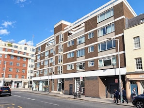 A multi-story building with a brick facade, large windows, and a flat roof. - The Elden - No.9 (London)
