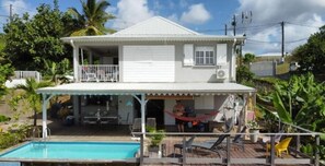 Enjoy a relaxing stay in this two-story residence with a covered patio and balcony overlooking a lush garden.