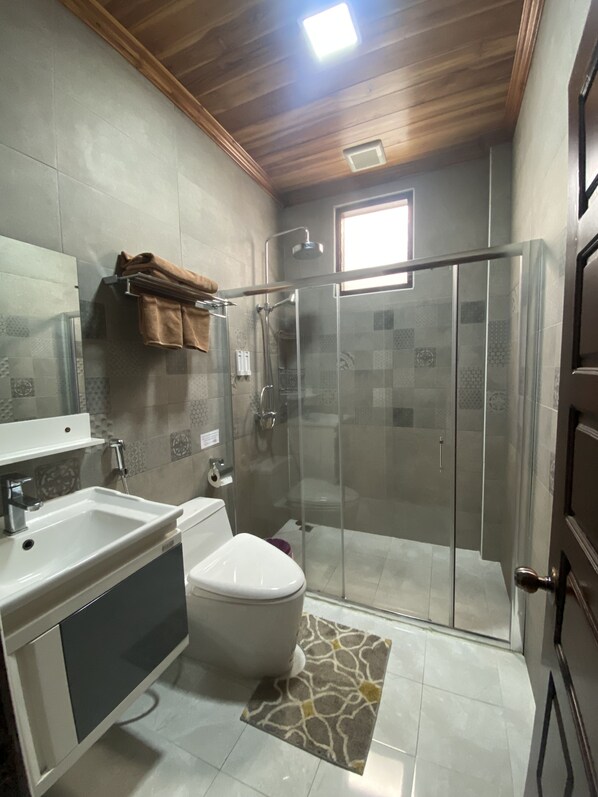 Shower, rainfall showerhead, slippers, towels
