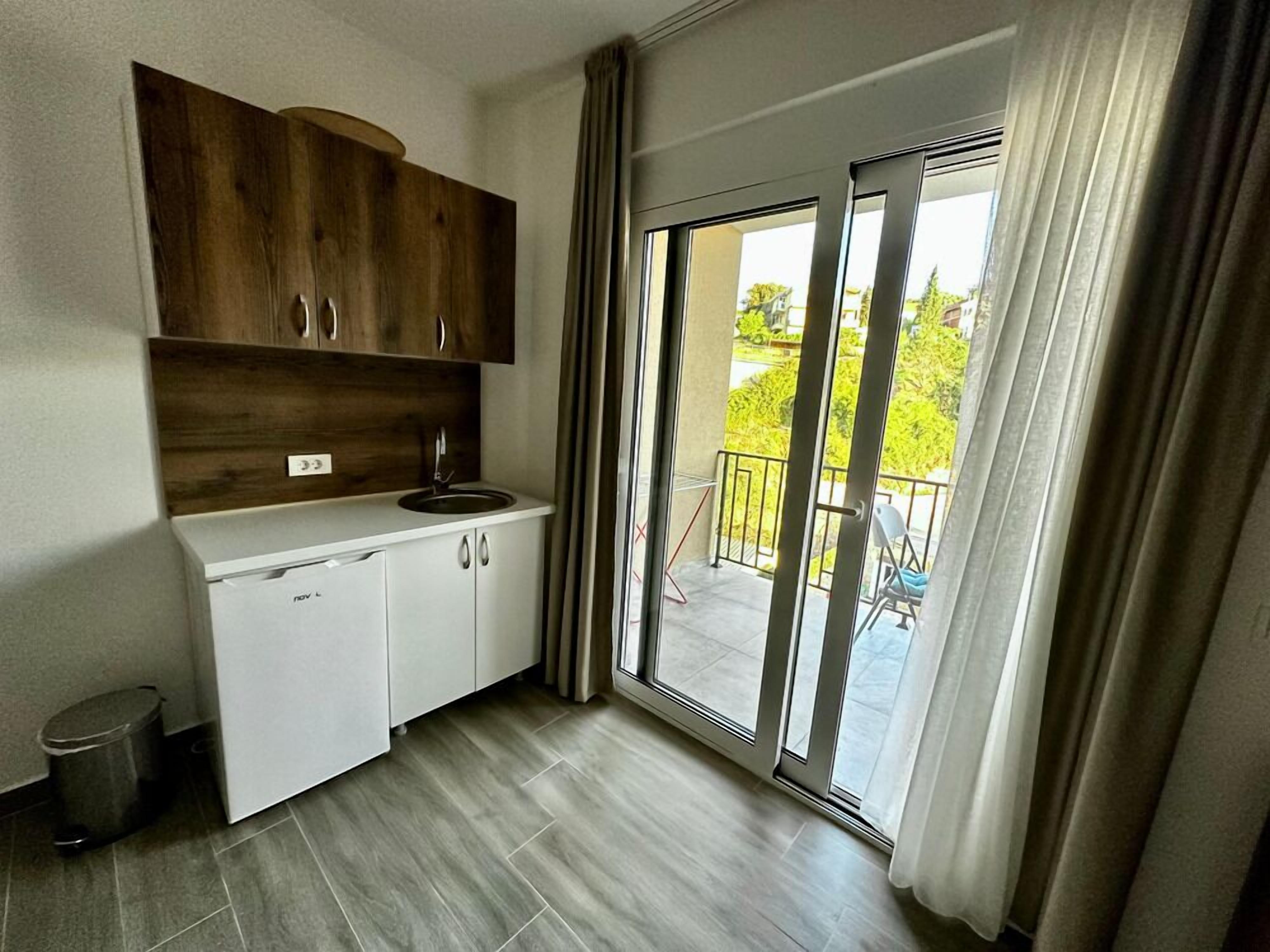 A modern kitchen with a built-in oven, a sink, and cabinets.