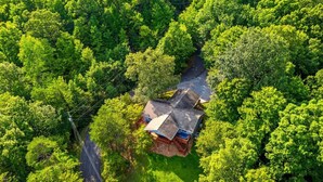 An aerial view of a house surrounded by dense green trees. - New! Private 2BR Cabin w/Hot Tub*Central Location (Sevierville)