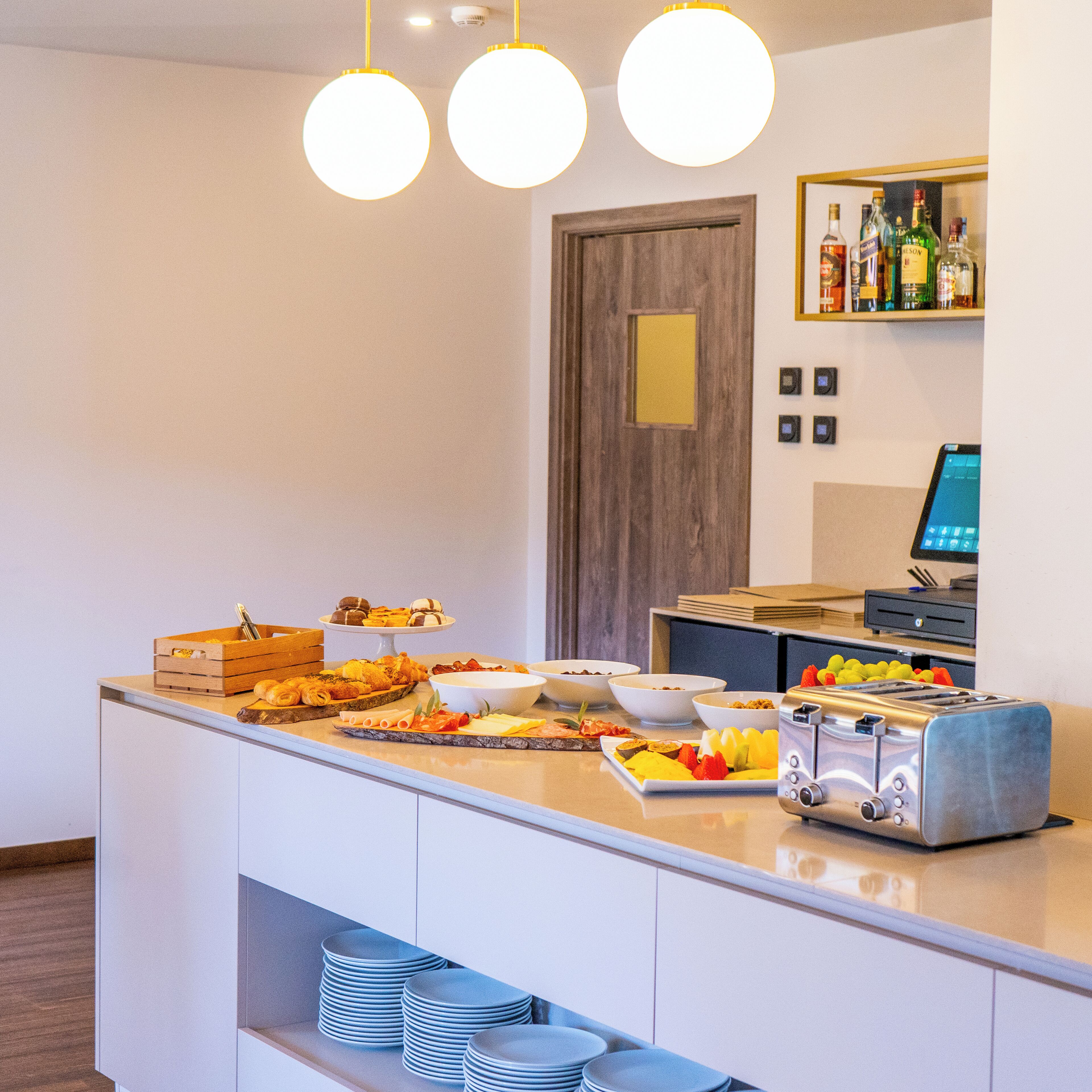 A buffet setup with various food items and a toaster.