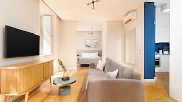 One-Bedroom Apartment | Living area | 55-inch flat-screen TV with cable channels