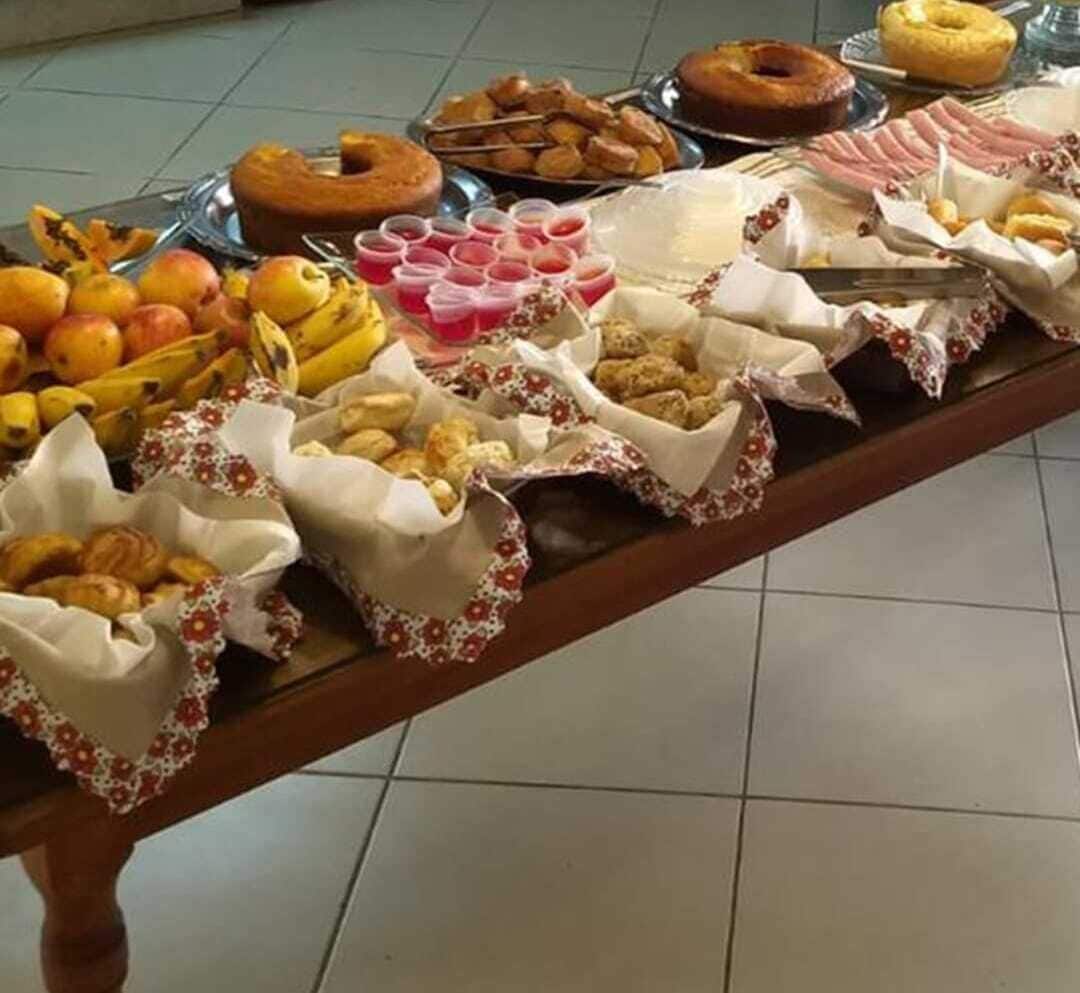 Una mesa de buffet con diversos alimentos, como frutas, pasteles y bebidas.