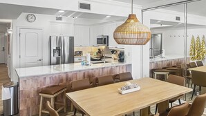 A modern kitchen with white cabinetry, stainless steel appliances, and a central island. - Azure #613 Updated Top Floor 3bdrm Sleeps 10! Views Galore! (Fort Walton Beach)