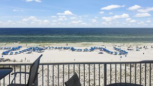 A beach with blue umbrellas and a view of the ocean. - Azure #613 Updated Top Floor 3bdrm Sleeps 10! Views Galore! (Fort Walton Beach)