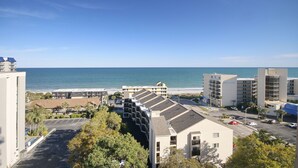 A coastal hotel with multiple buildings, a parking lot, and a view of the ocean. - Vacations By The Sea at Ocean Dunes Tower 1 (Myrtle Beach)